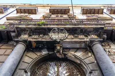 an entrance to an old building with pipes at Le Stanze del Conte in Palermo