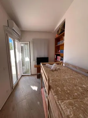 a bedroom with a bed and a desk and a window at Le Camere dell’Emiro in Castronuovo di Sicilia