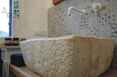 a large stone bath tub in a bathroom at Le Camere dell’Emiro in Castronuovo di Sicilia