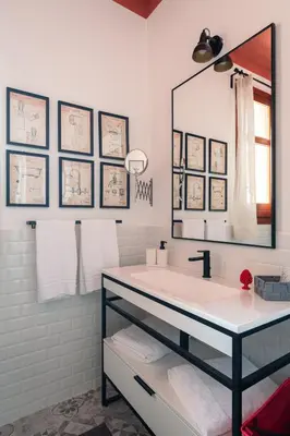 a bathroom with a sink and a large mirror at La casetta al Politeama in Palermo