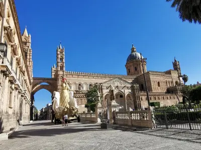a large building with a statue in front of it at La casetta al Politeama in Palermo