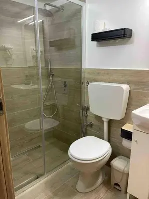 a bathroom with a toilet and a glass shower at Bella Sicilia in Palermo