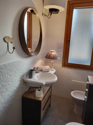 a small kitchen with white cabinets and a stove at cico appartamento in San Vito lo Capo