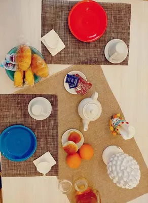 a table with plates and fruits and food on it at La Sicilia in casa in Cinisi