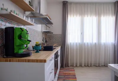 a kitchen with a green appliance on a counter at CENTRAL STATION APARTMENTS - Fanale Rentals in Palermo