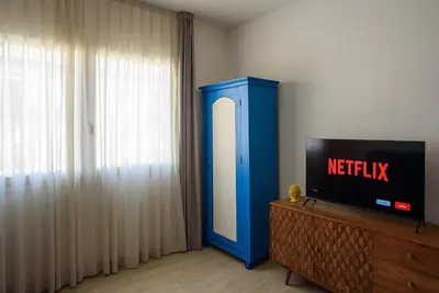 a television sitting on a dresser in a room at CENTRAL STATION APARTMENTS - Fanale Rentals in Palermo