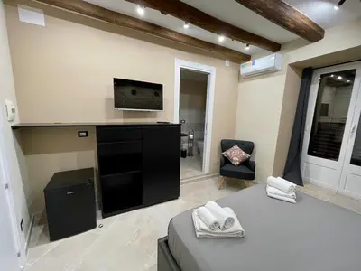 a large living room with a tv and a couch at Tommy's rooms in Palermo