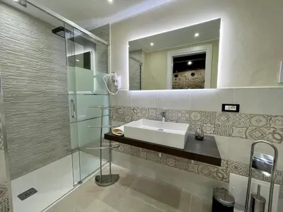 a bathroom with a sink and a mirror at Tommy's rooms in Palermo