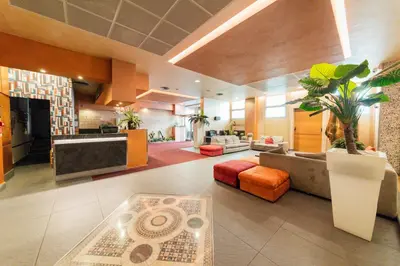 a living room with a couch and a table at Albergo Athenaeum in Palermo