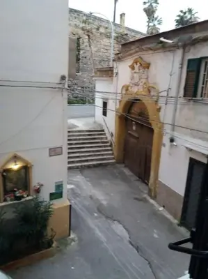 an alley with a building with a staircase and a door at Casa vacanza Sole di Sicilia in Palermo