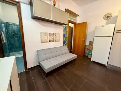 a living room with a shelf and a table at Mazzini House in Isola delle Femmine