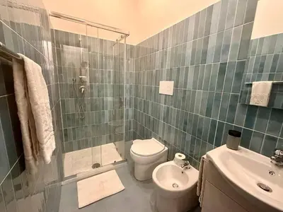 a bedroom with a bed with two white towels on it at Mazzini House in Isola delle Femmine