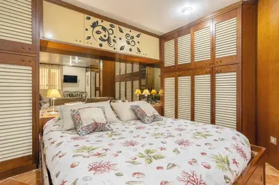a bedroom with a large bed in a room with windows at Casuzza casa vacanze in Palermo