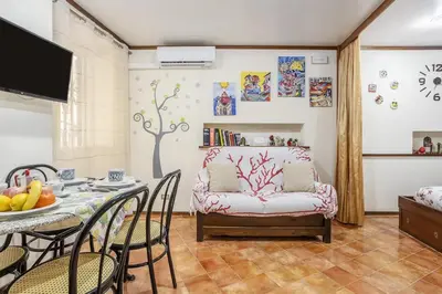 a living room with a table and a couch at Casuzza casa vacanze in Palermo