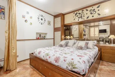 a bedroom with a large bed in a room at Casuzza casa vacanze in Palermo