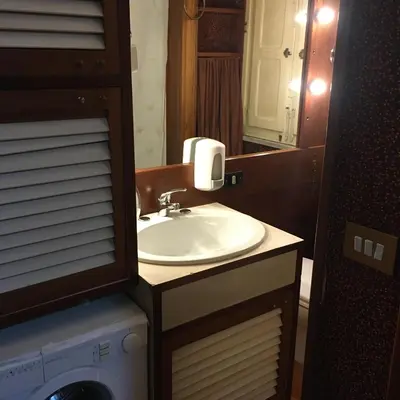 a bathroom with a sink and a mirror at Casuzza casa vacanze in Palermo