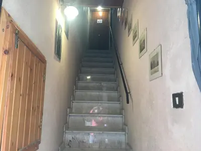 a set of stairs with a black door and a hallway at Casuzza casa vacanze in Palermo