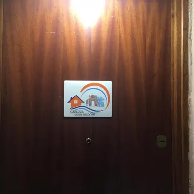 a sign on a door with a rainbow on it at Casuzza casa vacanze in Palermo