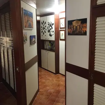 a hallway with some doors and some pictures on the wall at Casuzza casa vacanze in Palermo
