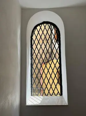 a window in a room with a lattice window at Cusciulìu House in Palermo