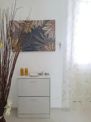 a dresser in a room with a painting on the wall at JEY STUDIO_INDEPENDENT SEAFRONT APARTMENT in Terrasini