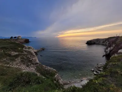 a view of the ocean with a sunset in the background at JEY STUDIO_INDEPENDENT SEAFRONT APARTMENT in Terrasini