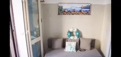 a room with a couch with a pillow and a picture on the wall at Posidonia in Porticello