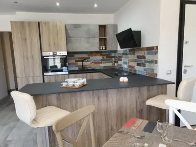 a kitchen with a counter with chairs and a table at Terra D'Aspra in Bagheria