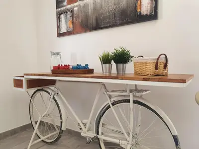 a white bike with a wooden table on top at Terra D'Aspra in Bagheria