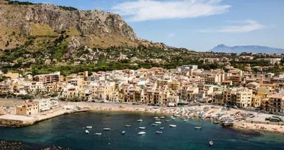 a group of buildings and boats in a harbor at Terra D'Aspra in Bagheria