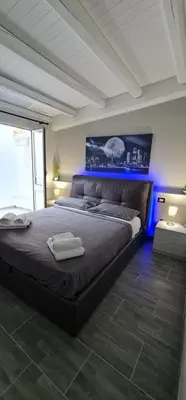 a bedroom with a large bed with a blue light at Havana in Palermo