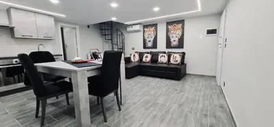 a kitchen with a table and black chairs in a room at Havana in Palermo