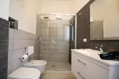 a bathroom with a shower and a toilet and a sink at CASA IL LIMONE 300M MARE PARK e GIARDINO PRIV WIFI in San Vito lo Capo
