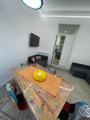 a room with a table with a yellow item on it at Tiski Toski Apartments Palermo in Palermo