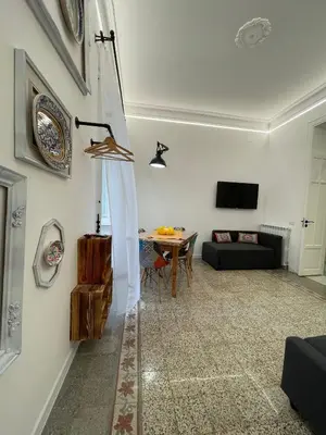 a living room with a couch and a table at Tiski Toski Apartments Palermo in Palermo