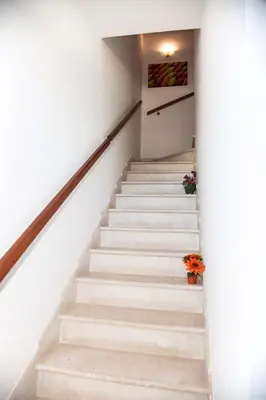 a stairway leading up to the second floor of a building at Case Vacanza Sabbia Rosa in San Vito lo Capo