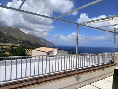 a balcony with a view of the ocean at La casetta a Scopello in Scopello