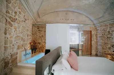 a bedroom with a bed and a bath tub at Ambrosia-Timeless Hosting in Palermo