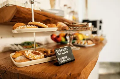 a counter with various pastries and a sign on it at Ambrosia-Timeless Hosting in Palermo