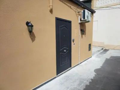 a black door on the side of a building at IGIEA ROOMS in Palermo
