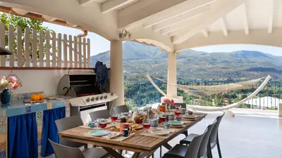 a table in a kitchen with a view at VILLA OLIMPIA 6&2, Emma Villas in Castellammare del Golfo