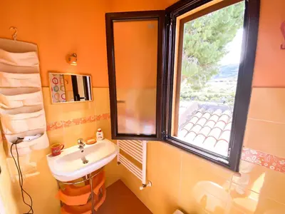 a bathroom with a sink and a window at Scopello Home in Castellammare del Golfo
