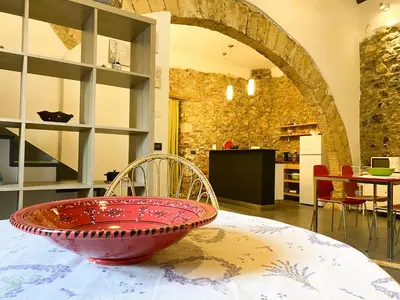 a red bowl sitting on top of a table at Scopello Home in Castellammare del Golfo