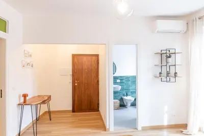 a kitchen with white brick walls and a sink at NicolHouse - Appartamento nel centro storico di Palermo in Palermo
