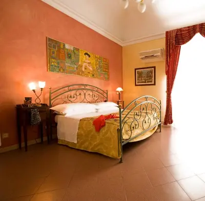a bedroom with a bed in a room at Hotel Joli in Palermo