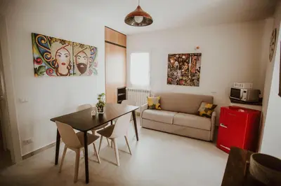 a living room with a table and a couch at Casa Vacanze Galati in Palermo
