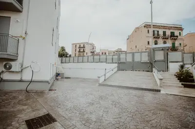 a balcony of a building with stairs and a fence at Casa Vacanze Galati in Palermo