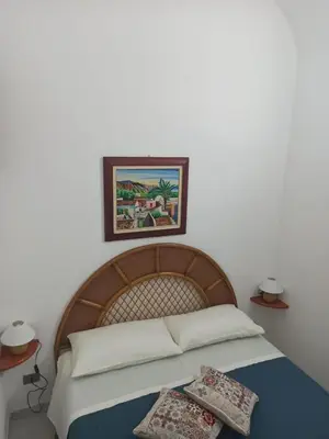 a bedroom with a bed with two pillows on it at CASETTA PONENTE in Isola delle Femmine