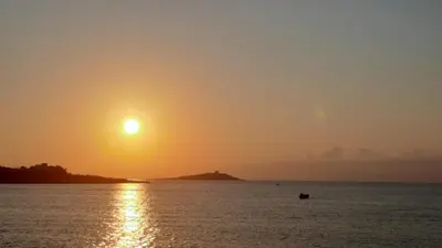 an orange and red sunset over the water at CASETTA PONENTE in Isola delle Femmine