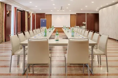 a large conference room with a long table and chairs at NH Palermo in Palermo